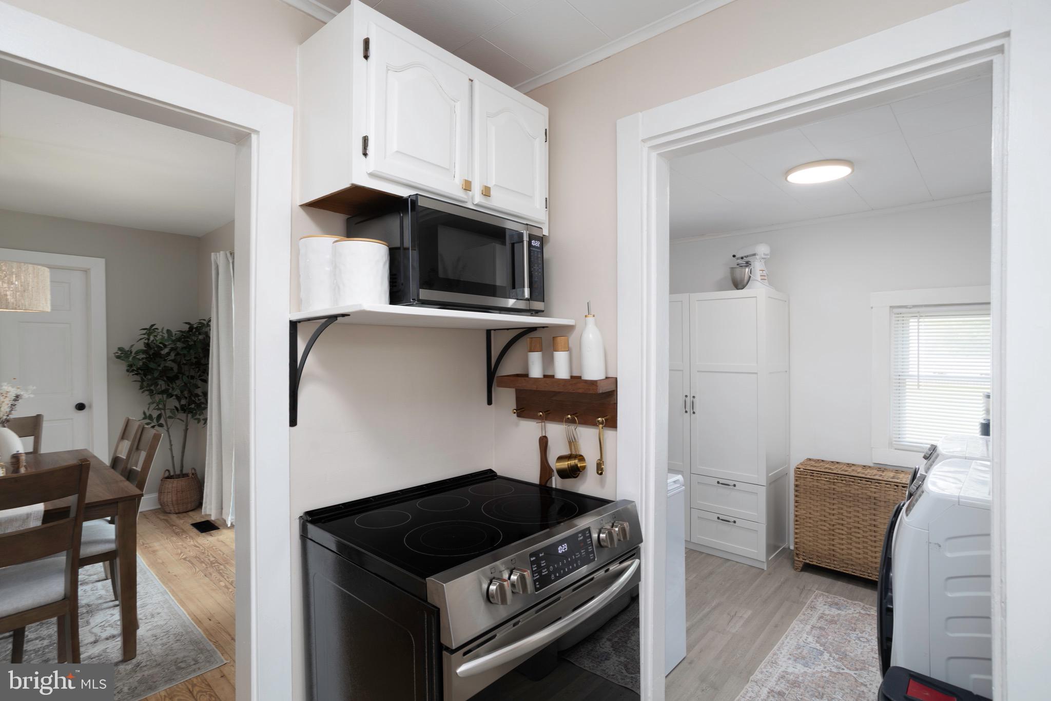529 North 6th Street Denton, MD 21629 - Photo 9 of 21 a kitchen with stainless steel appliances a stove a microwave and a refrigerator
