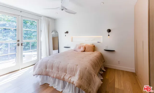 a bedroom with a bed and a large window