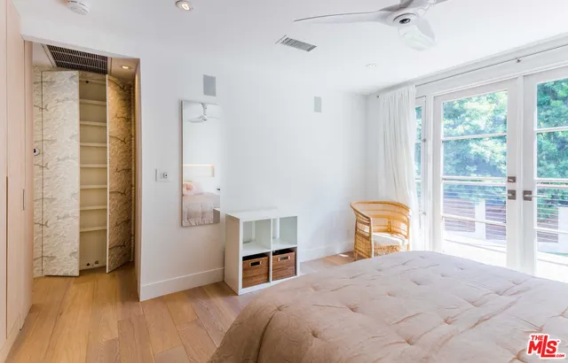 a bedroom with a bed and a large window