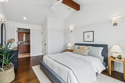 a bedroom with bed and wooden floor