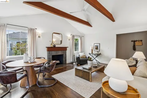 a living room with furniture a fireplace and a large window