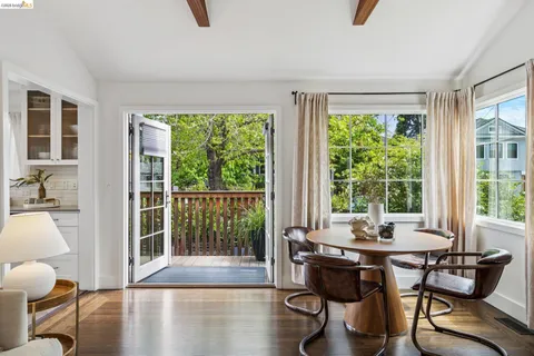 a dining room with furniture and wooden floor
