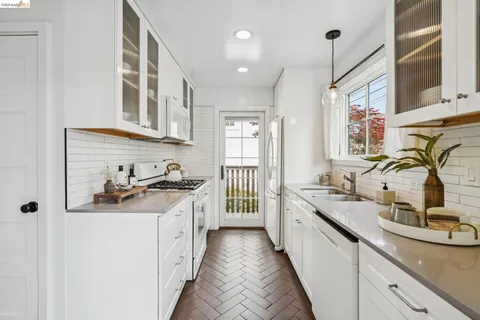 a kitchen with a sink stove and cabinets