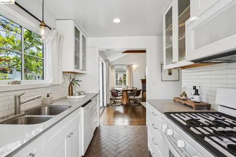 a kitchen with stainless steel appliances granite countertop a sink stove and cabinets