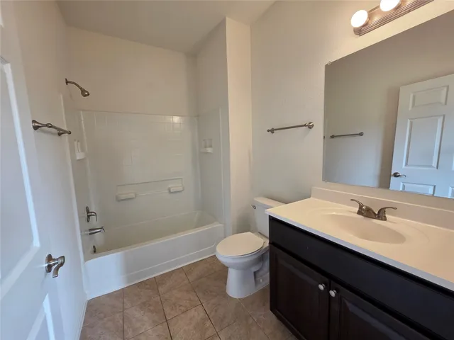 a bathroom with a sink a toilet a shower and a mirror