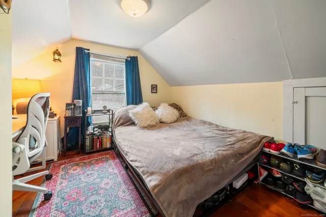 a bedroom with a bed and a tv on the table