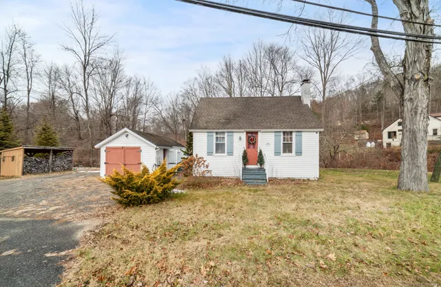a view of a house with a yard covered in snow
