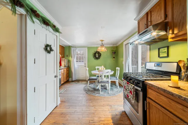 a view of a kitchen with a table and chairs