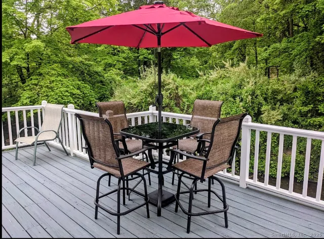 a view of balcony with wooden floor and outdoor seating