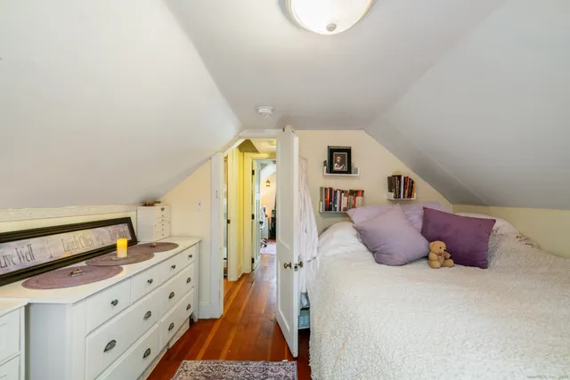 a bedroom with a bed and a dresser