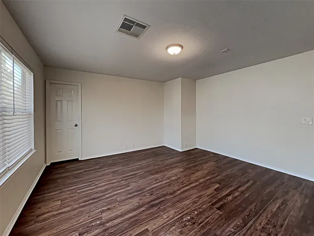 an empty room with wooden floor