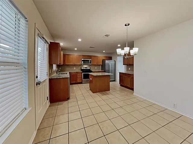 a kitchen with stainless steel appliances a refrigerator sink and microwave