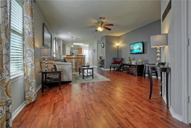a living room with furniture and a wooden floor