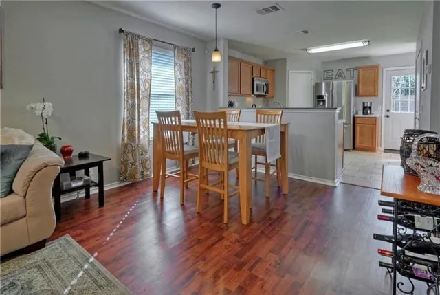 a living room with furniture dining table and wooden floor