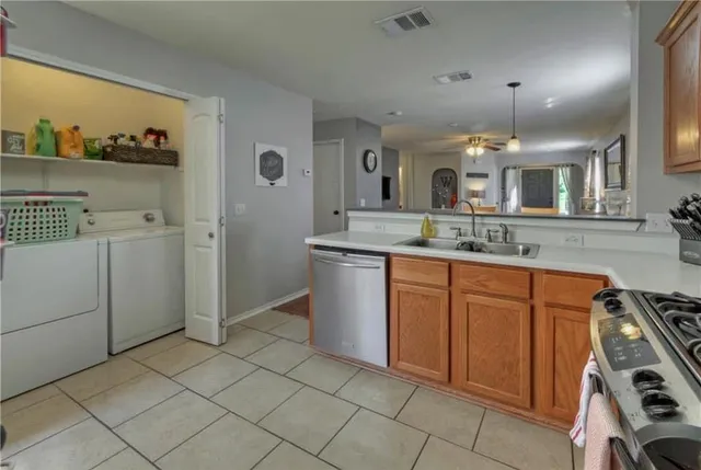 a kitchen with stainless steel appliances granite countertop a sink and cabinets
