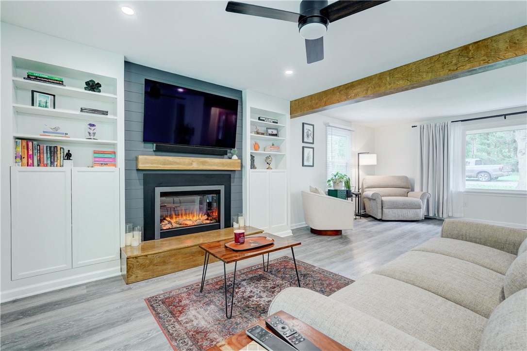 View of electric fireplace and built in shelves/st
