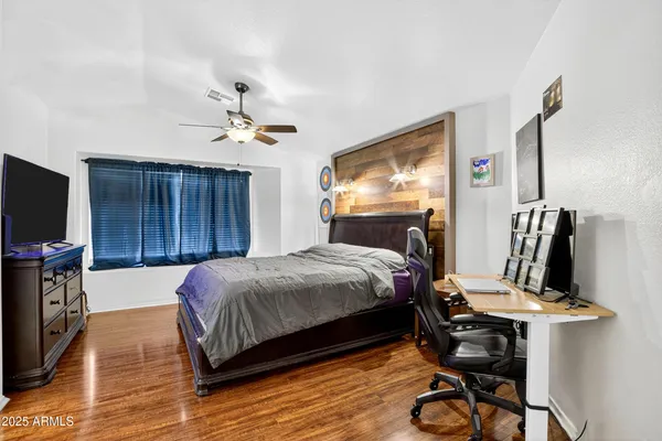 a bed room with a bed tv and a mirror