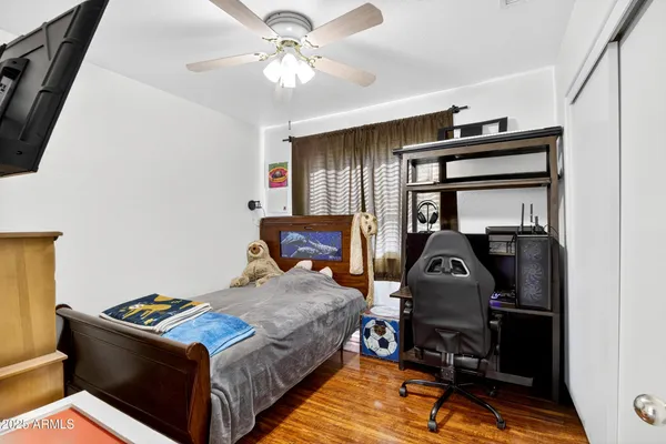 a bedroom with a bed and wooden floor