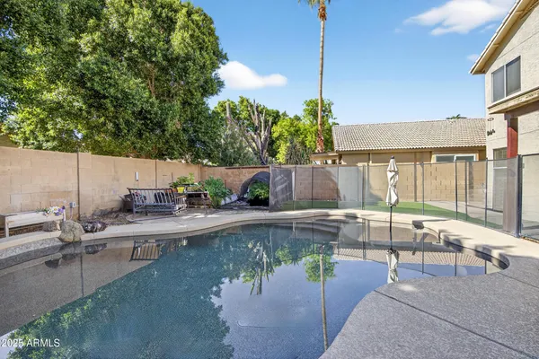 a view of a house with backyard and sitting area