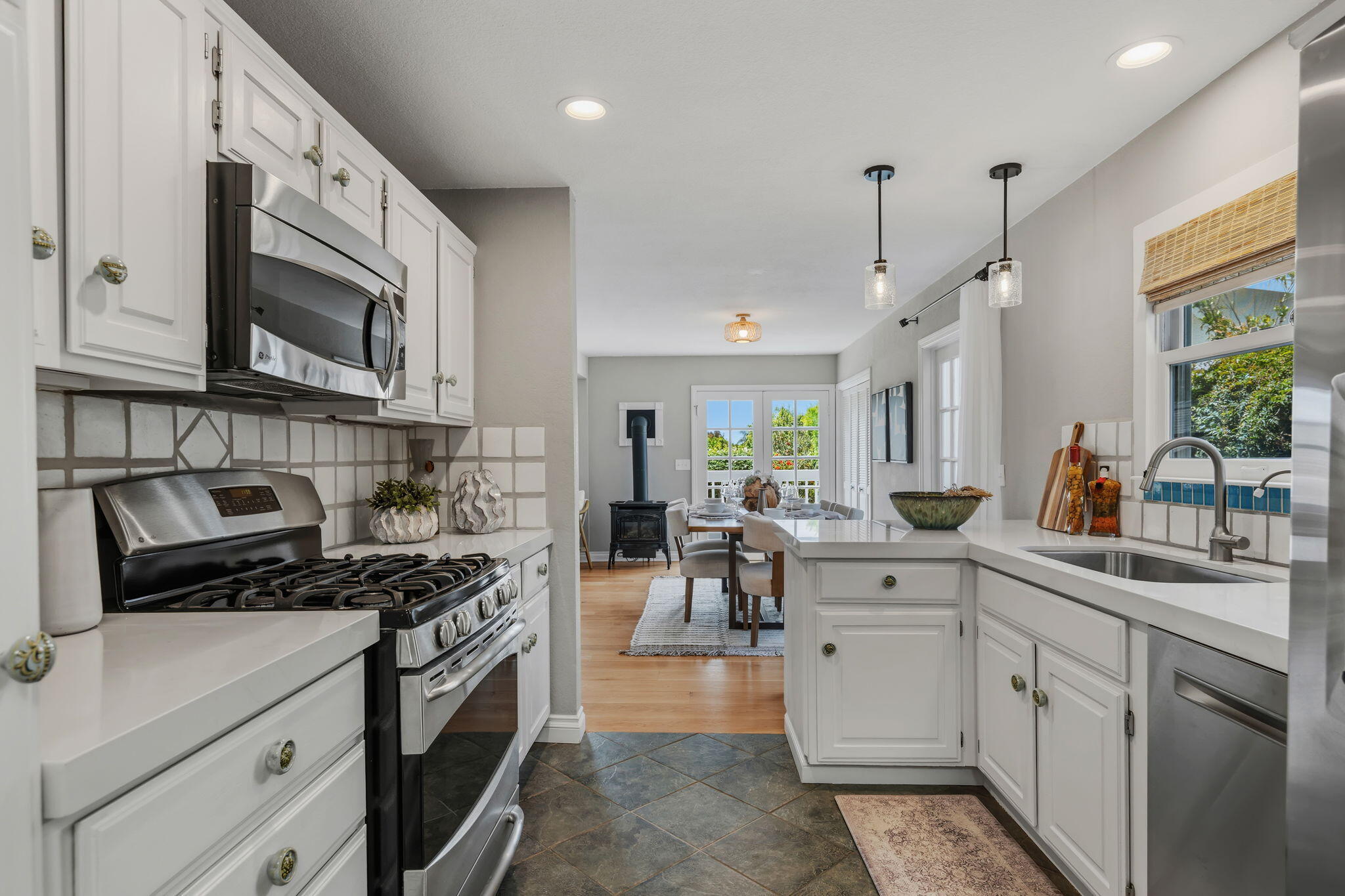 2129 Red Rose Way Santa Barbara, CA 93109 - Photo 3 of 44 a kitchen with stainless steel appliances granite countertop a stove a sink and a microwave
