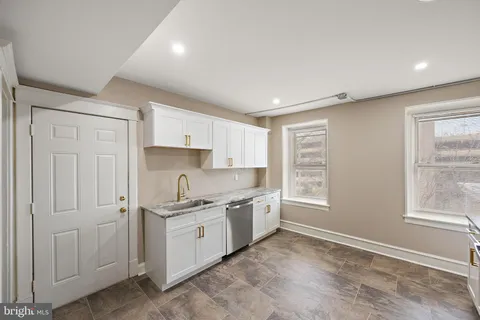 a kitchen with a sink stove and cabinets