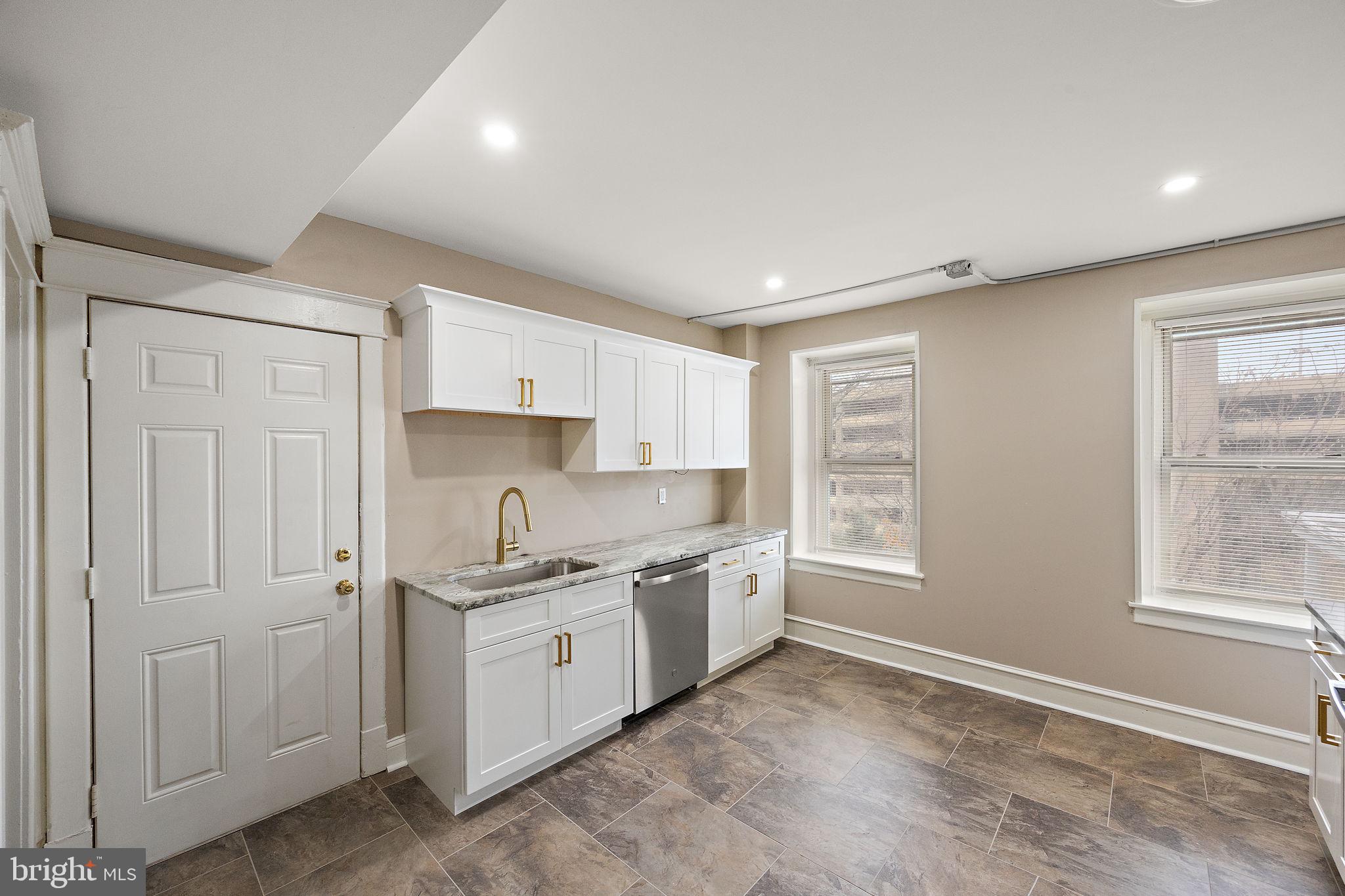 1522 West 7th Street, Unit 3 Wilmington, DE 19805 - Photo 12 of 13 a kitchen with a sink stove and cabinets