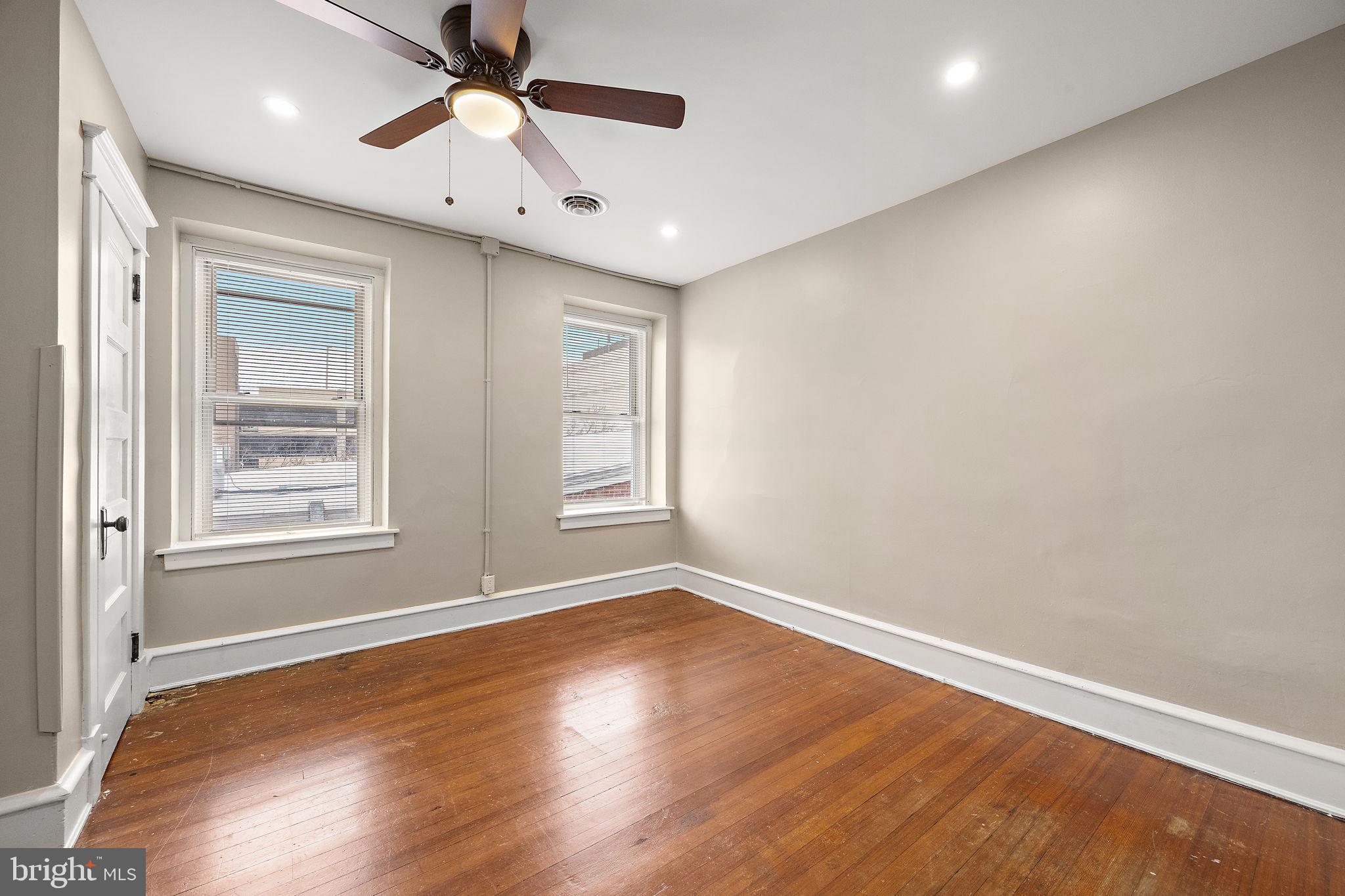 1522 West 7th Street, Unit 3 Wilmington, DE 19805 - Photo 3 of 13 wooden floor in an empty room with a window