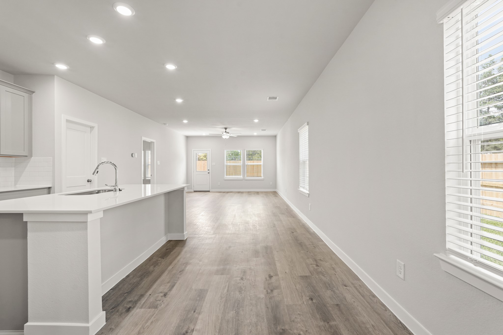 213 Spring Drive Hockley, TX 77447 - Photo 4 of 26 a big room with wooden floor and windows