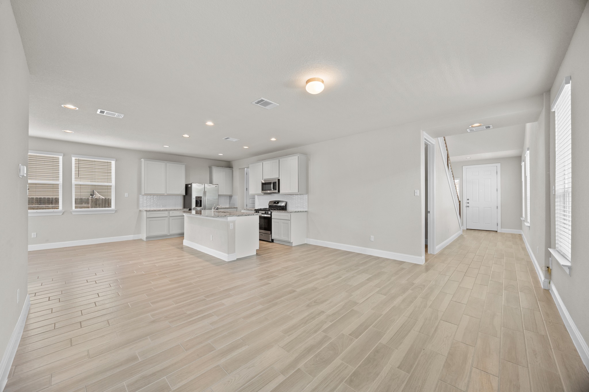 213 Graver Street Georgetown, TX 78626 - Photo 7 of 33 An inviting open-concept layout unites kitchen and living spaces for effortless entertaining.