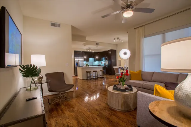 a living room with furniture and kitchen view