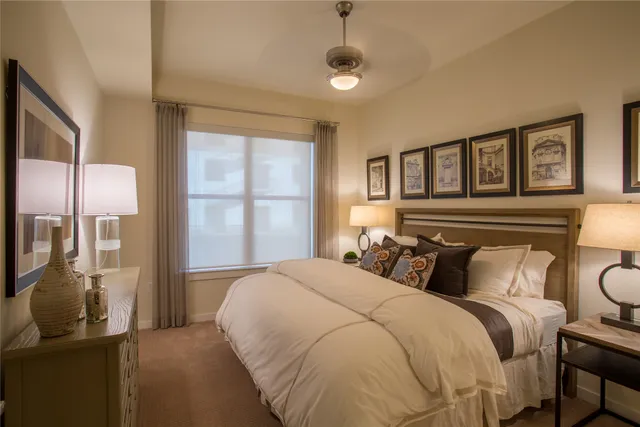 a bedroom with a large bed and a window