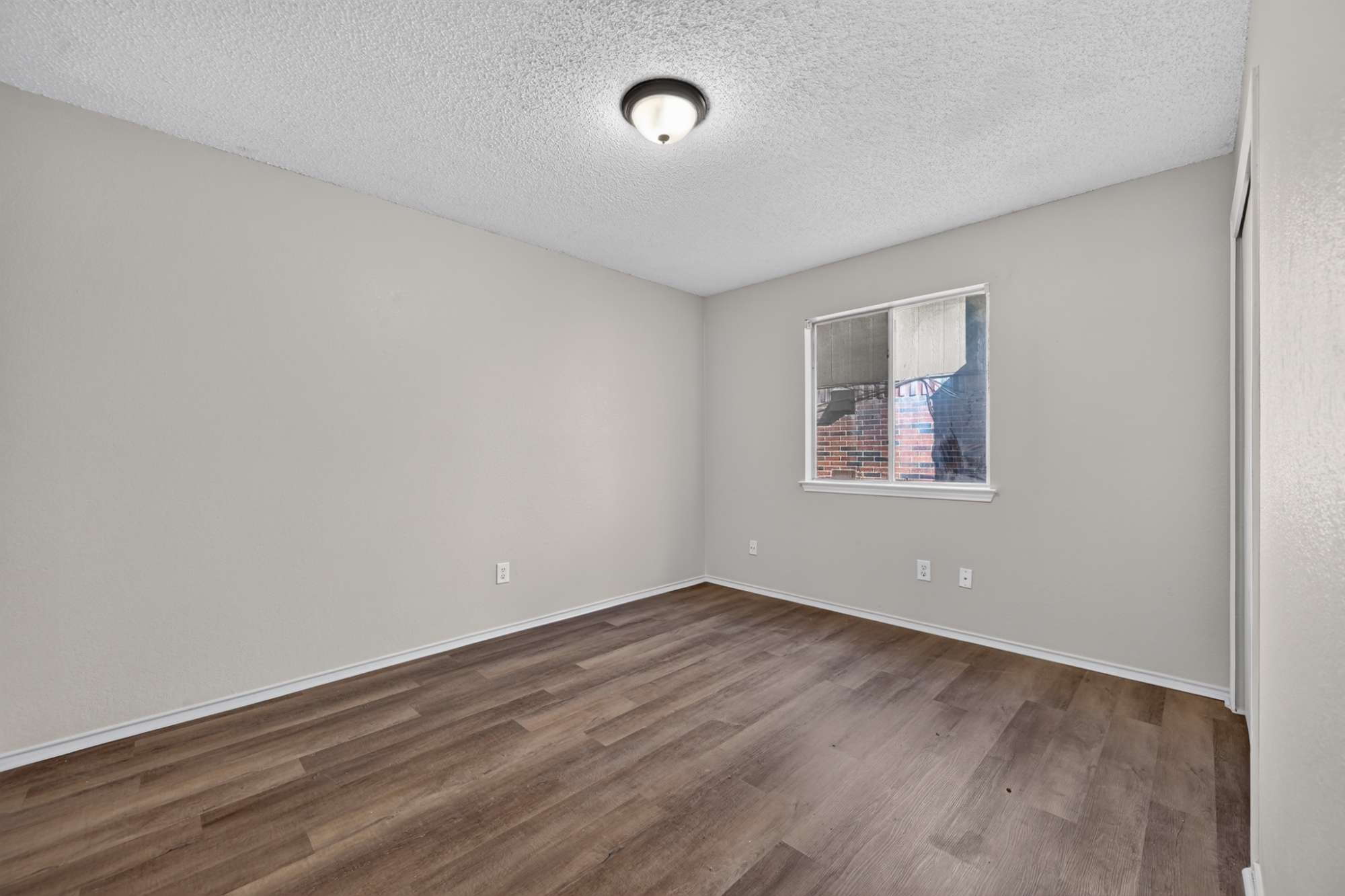 904 Nelson Ranch Road Cedar Park, TX 78613 - Photo 14 of 21 Rich wood-inspired flooring and a wide window define this versatile secondary bedroom space.