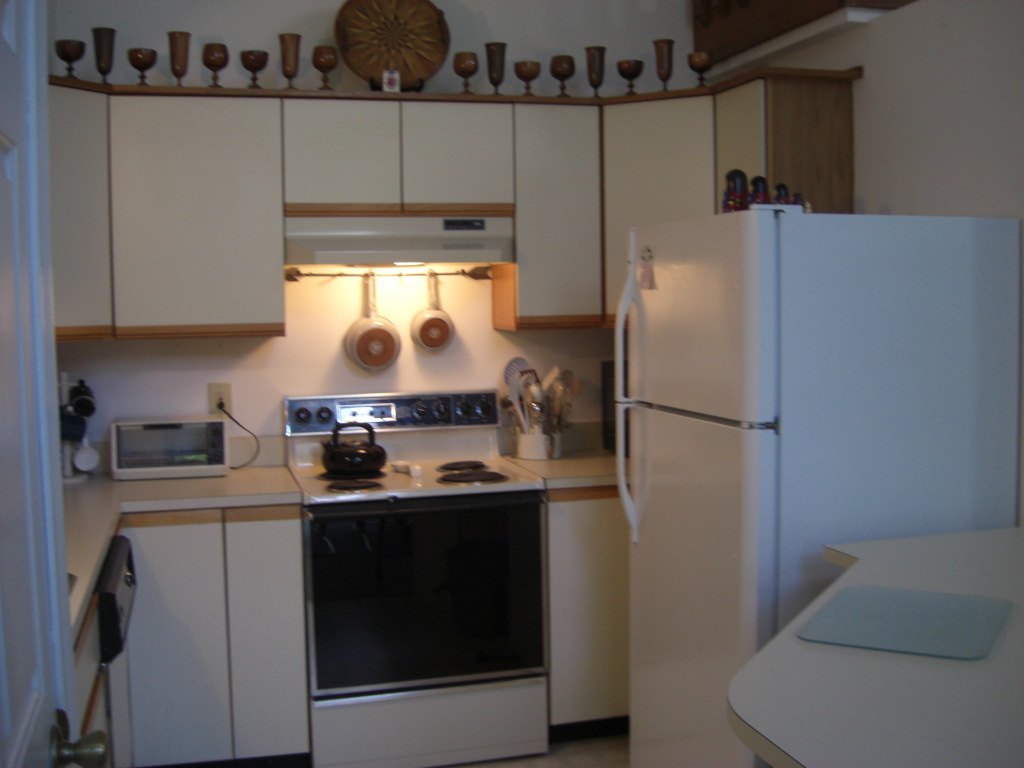 564 Leonhardt Road Becket, MA 01223 - Photo 11 of 11 a kitchen with a sink a refrigerator and cabinets