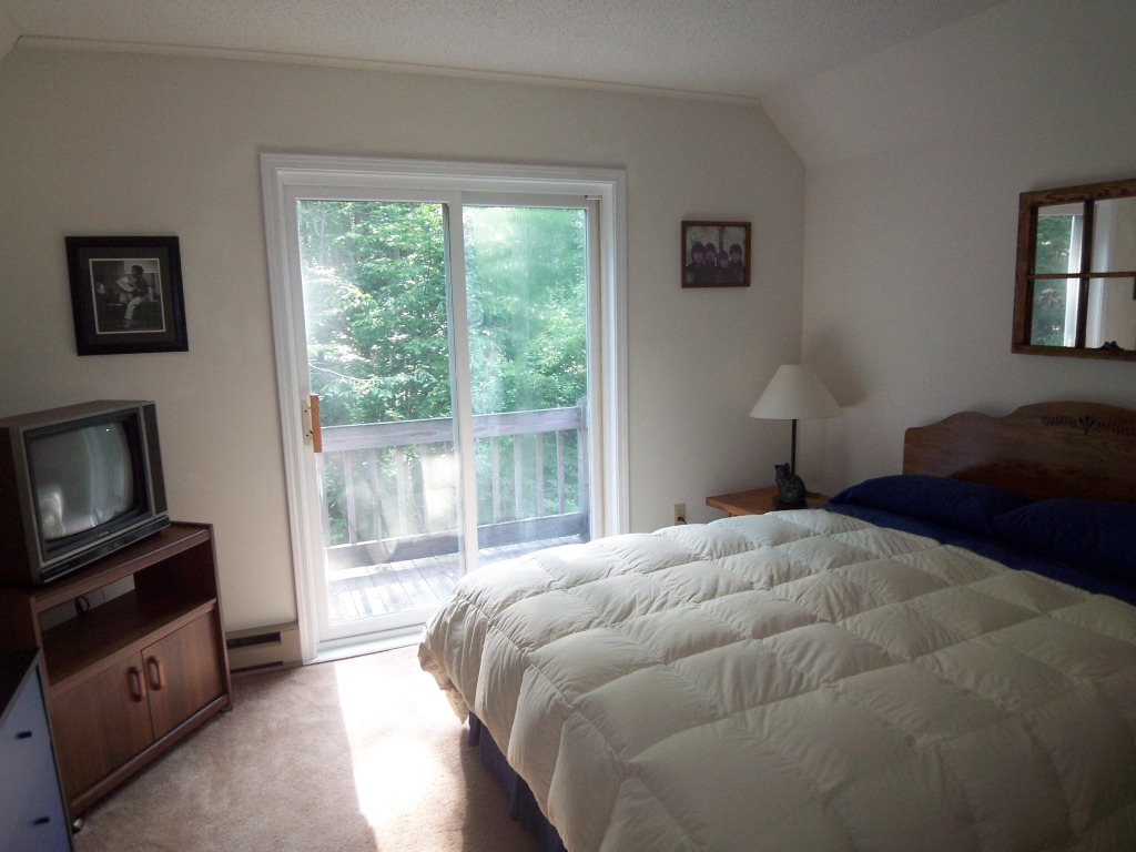 564 Leonhardt Road Becket, MA 01223 - Photo 5 of 11 a bedroom with a bed and a television