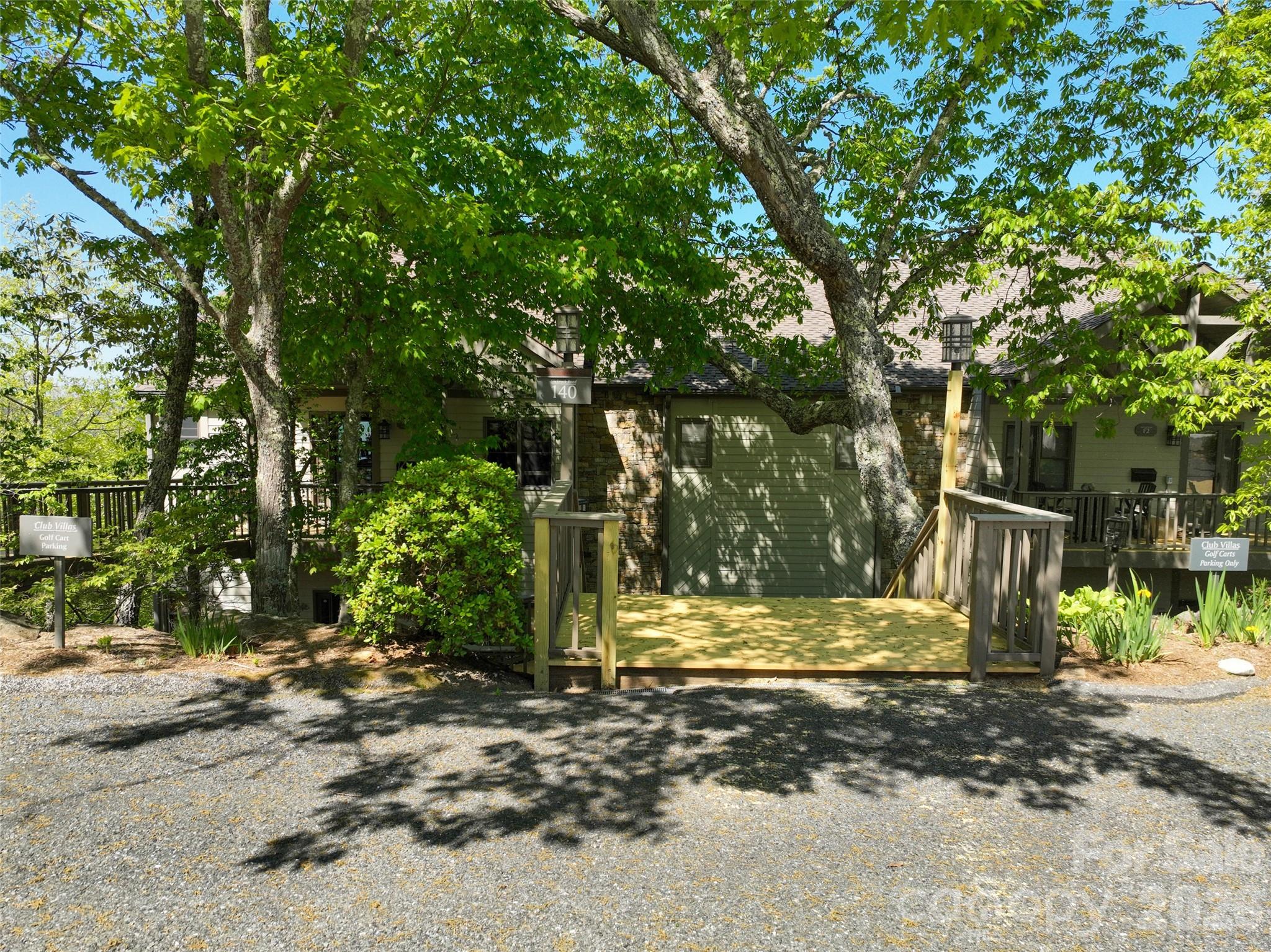 140 Slickrock Road, Unit F4 Burnsville, NC 28714 - Photo 2 of 41 a view of a tree in the middle of a yard