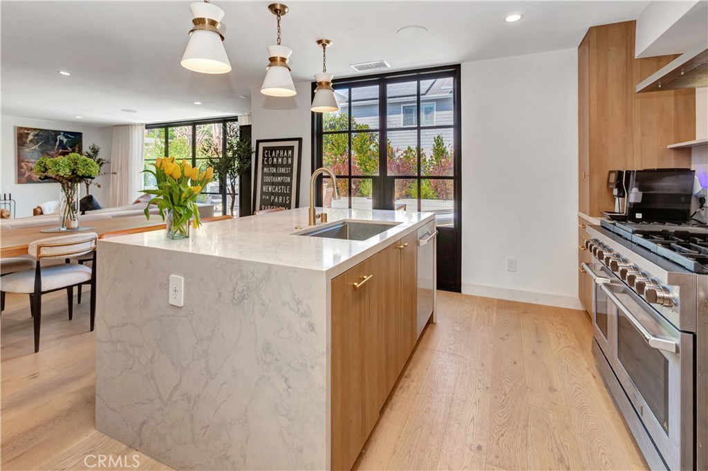 418 East 16th Street Costa Mesa, CA 92627 - Photo 13 of 28 a kitchen with stainless steel appliances granite countertop a sink and cabinets