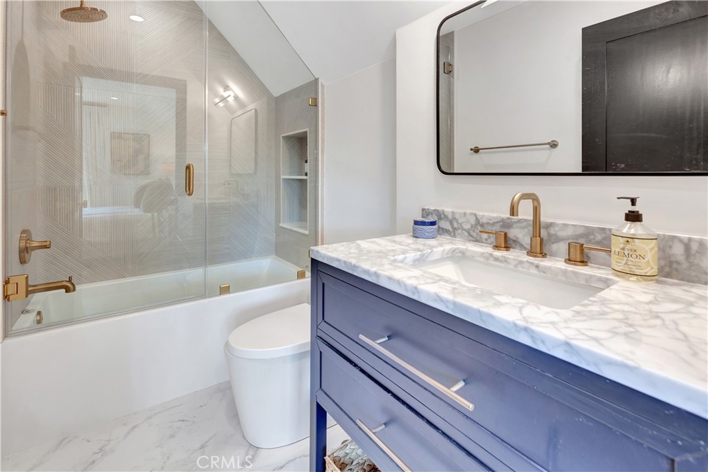 418 East 16th Street Costa Mesa, CA 92627 - Photo 15 of 28 a bathroom with a granite countertop sink a toilet a mirror and bathtub