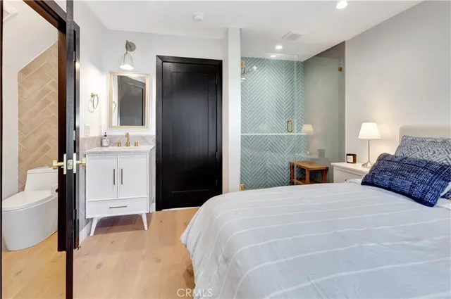 a bedroom with a bed and a large mirror