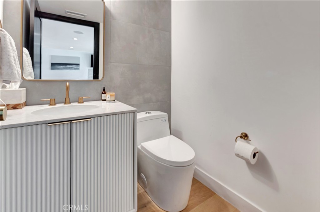 418 East 16th Street Costa Mesa, CA 92627 - Photo 19 of 28 a bathroom with a sink a toilet and mirror