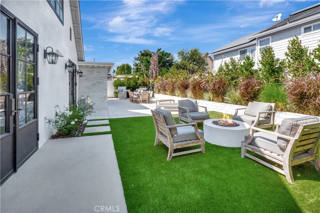 418 East 16th Street Costa Mesa, CA 92627 - Photo 25 of 28 a view of a patio with couches chairs potted plants and a big yard