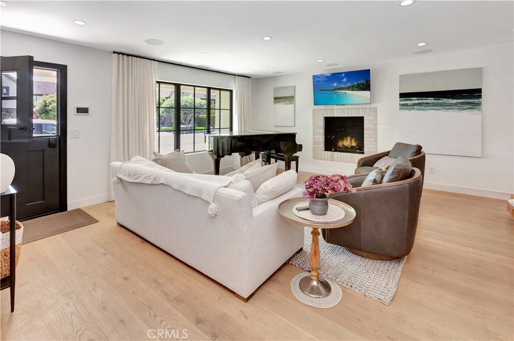 418 East 16th Street Costa Mesa, CA 92627 - Photo 6 of 28 a living room with furniture a fireplace and a flat screen tv