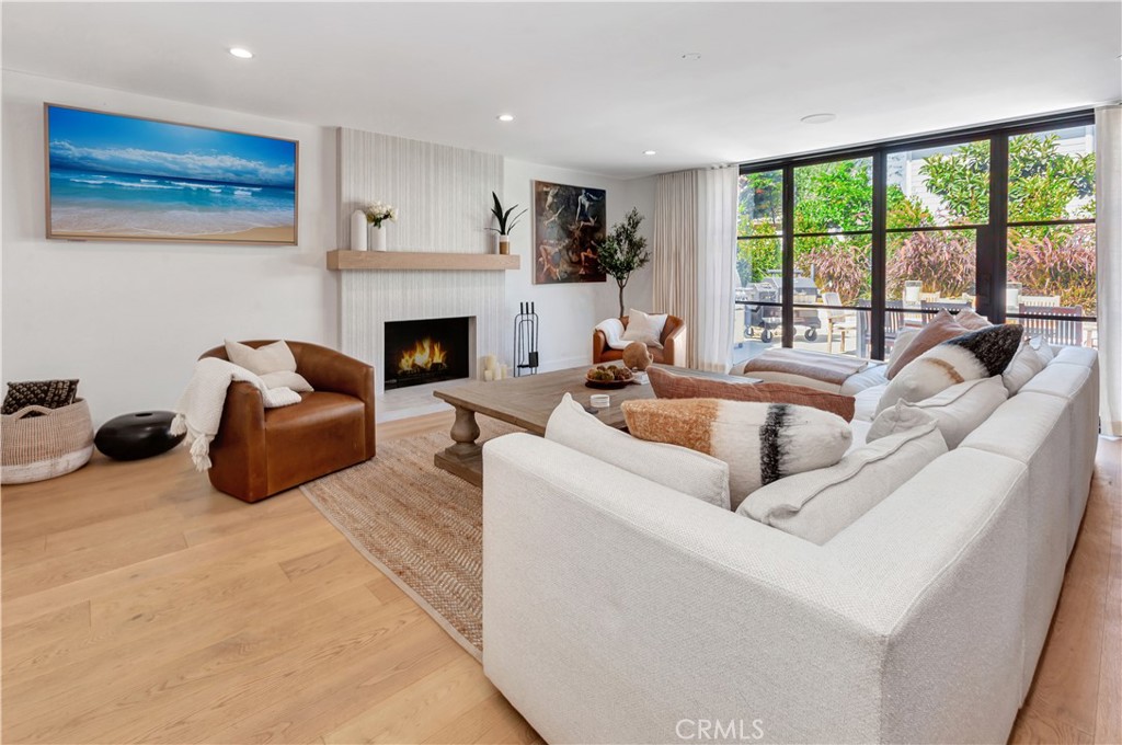 418 East 16th Street Costa Mesa, CA 92627 - Photo 7 of 28 a living room with furniture a fireplace and a large window