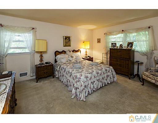 1 Timber Road Edison, NJ 08820 - Photo 16 of 22 a bedroom with a bed and wooden floor