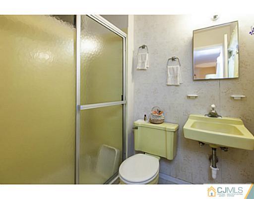 1 Timber Road Edison, NJ 08820 - Photo 17 of 22 a bathroom with a sink toilet and a mirror