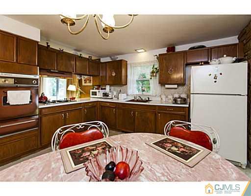 1 Timber Road Edison, NJ 08820 - Photo 6 of 22 a kitchen with a refrigerator and a sink