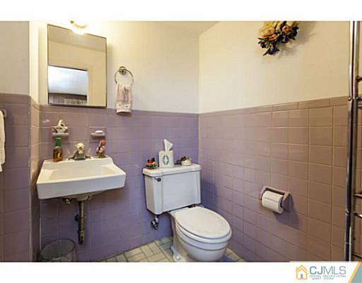 1 Timber Road Edison, NJ 08820 - Photo 9 of 22 a bathroom with a sink mirror and toilet