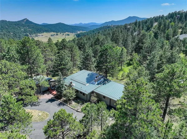 an aerial view of a house with mountain view