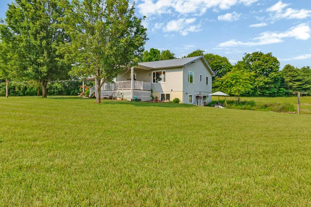 a front view of house with yard and green space