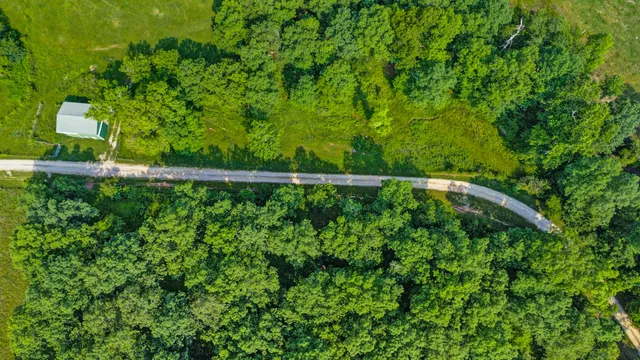 a backyard of a house with lots of green space and garden in the back