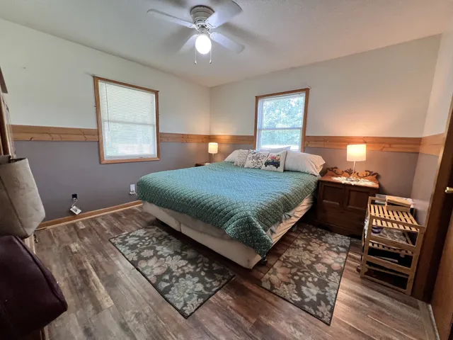 a dining room with furniture and a large window